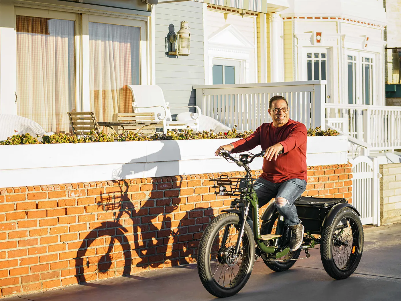 An Addmotor electric adult tricycle with front and rear baskets.