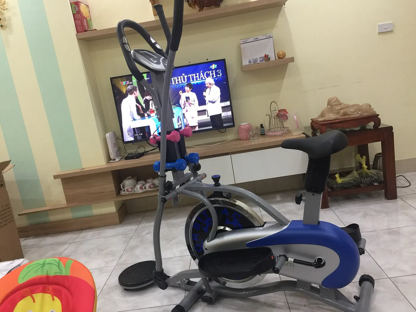 A stationary exercise bicycle positioned indoors.