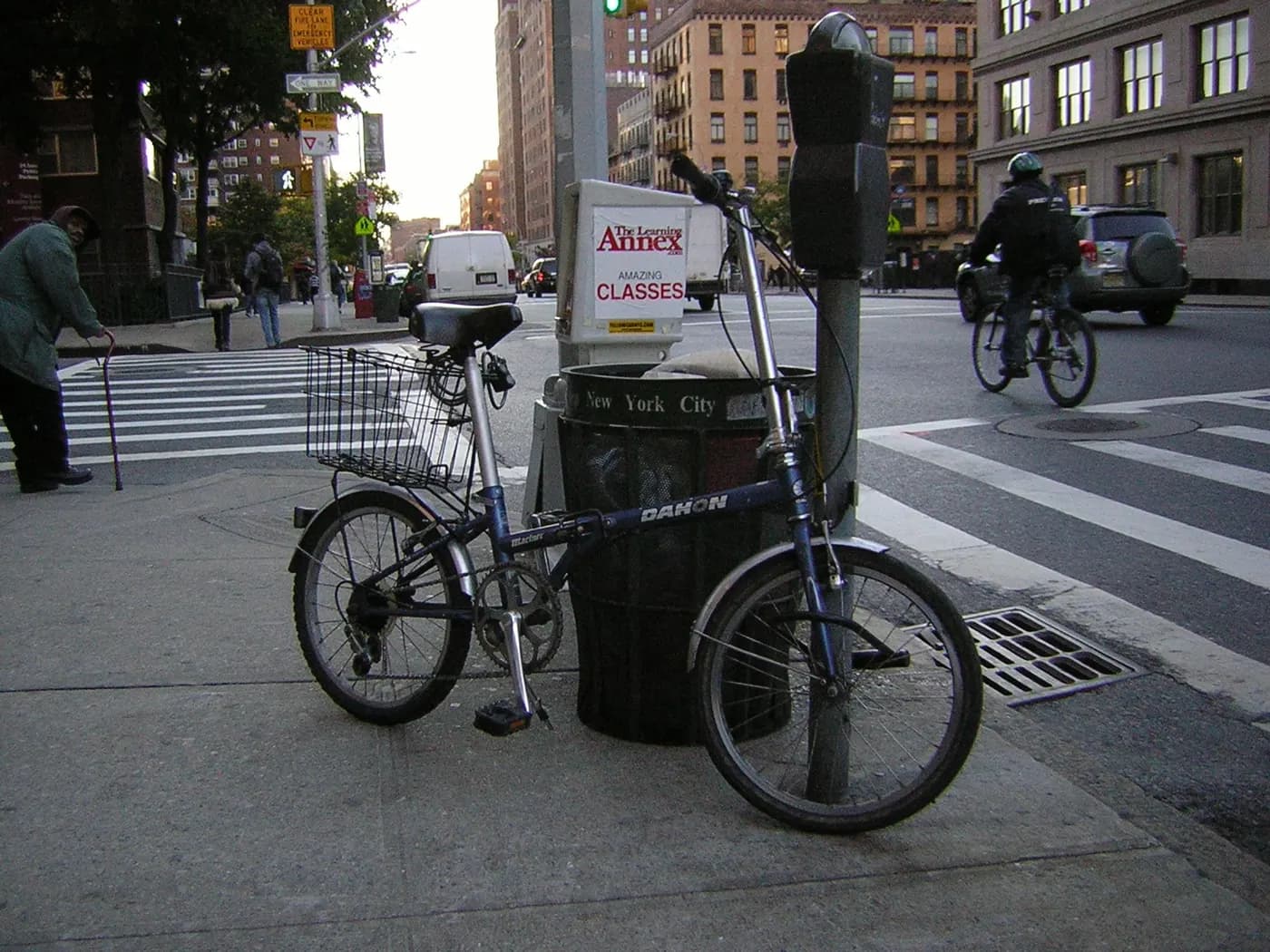 Folding bicycle attached near an urban railing