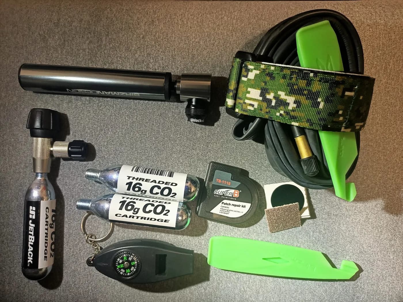 A compact emergency kit containing a tube, inflation equipment, and tire tools.