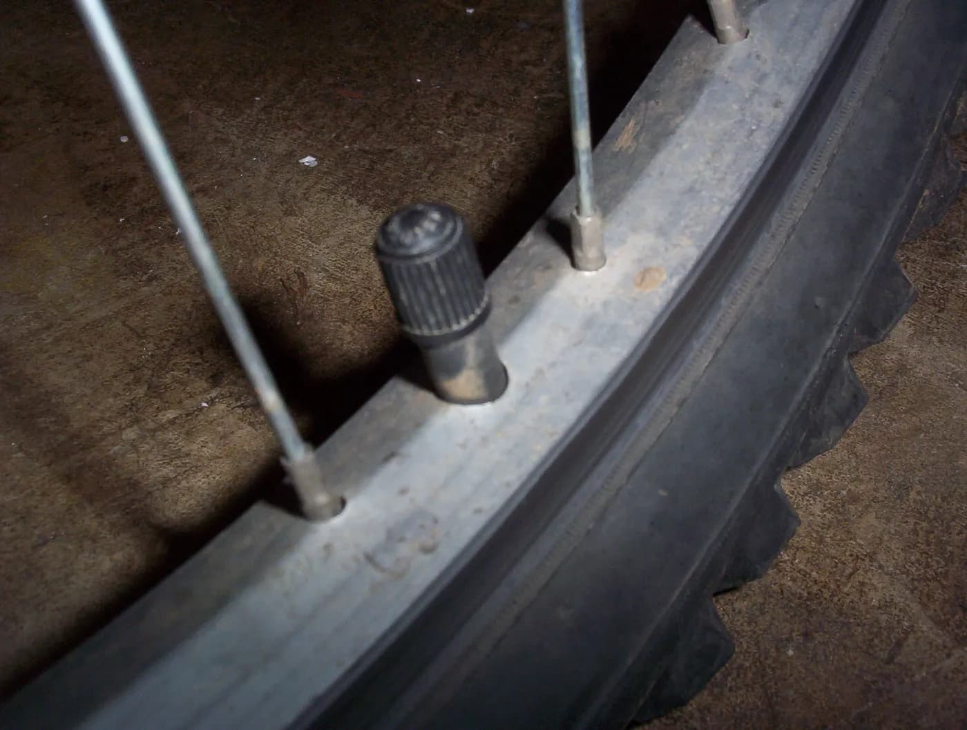 A Schrader valve on a bicycle wheel.