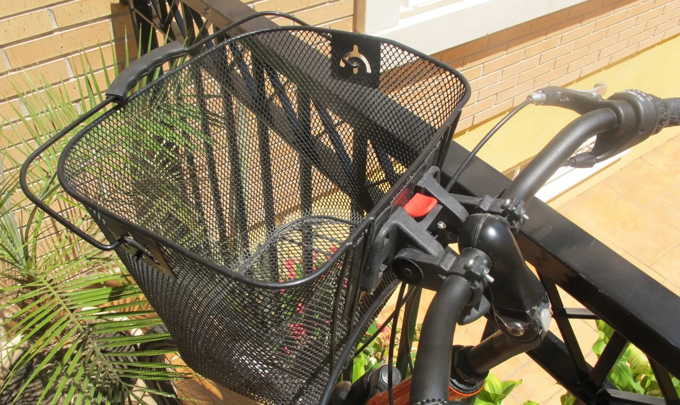 A bicycle basket attached to a two-wheel bicycle.