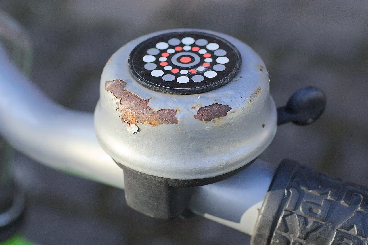 Rusty bell mounted on a child's bicycle handlebar