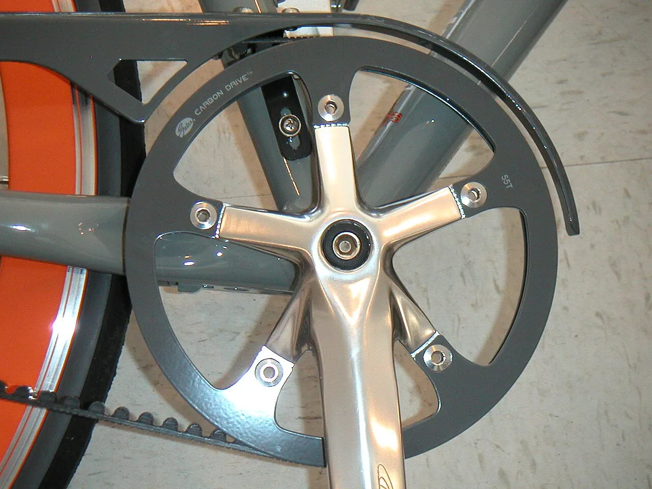 Belt-drive crankset and toothed belt on a conventional bicycle