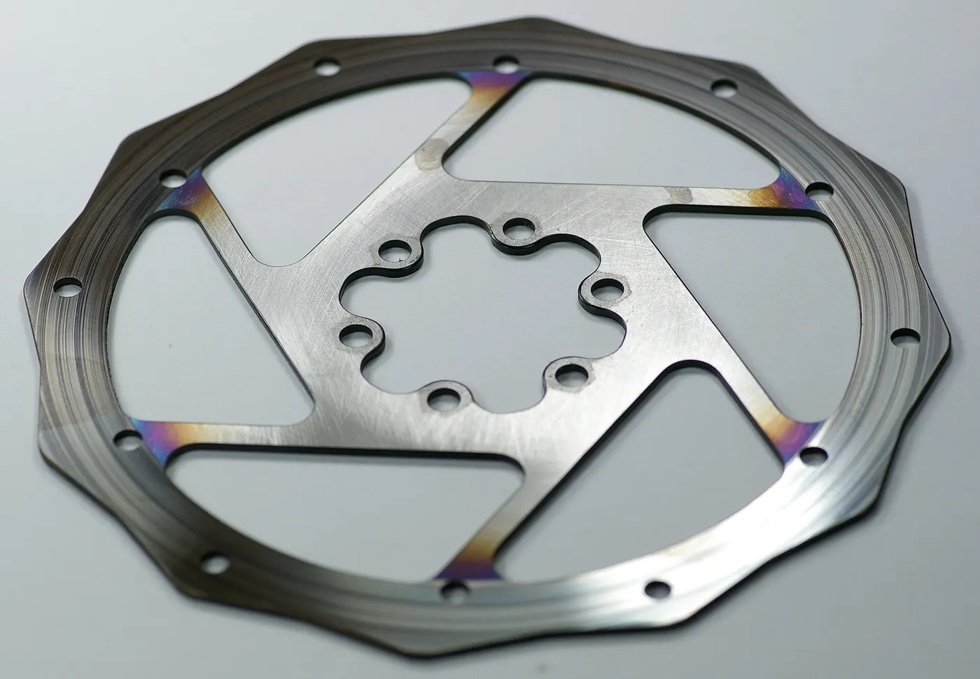 A bicycle disc rotor showing heat discoloration near its inner area.