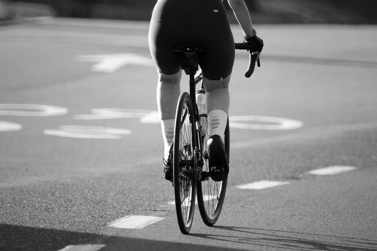 Cyclist riding a road bicycle in a monochrome photograph