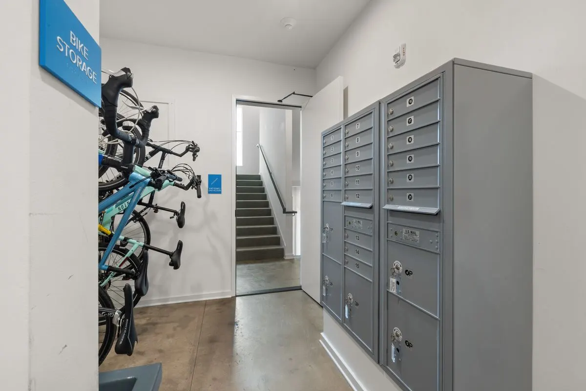 Indoor bike storage and mailroom with lockers, modern and organized.