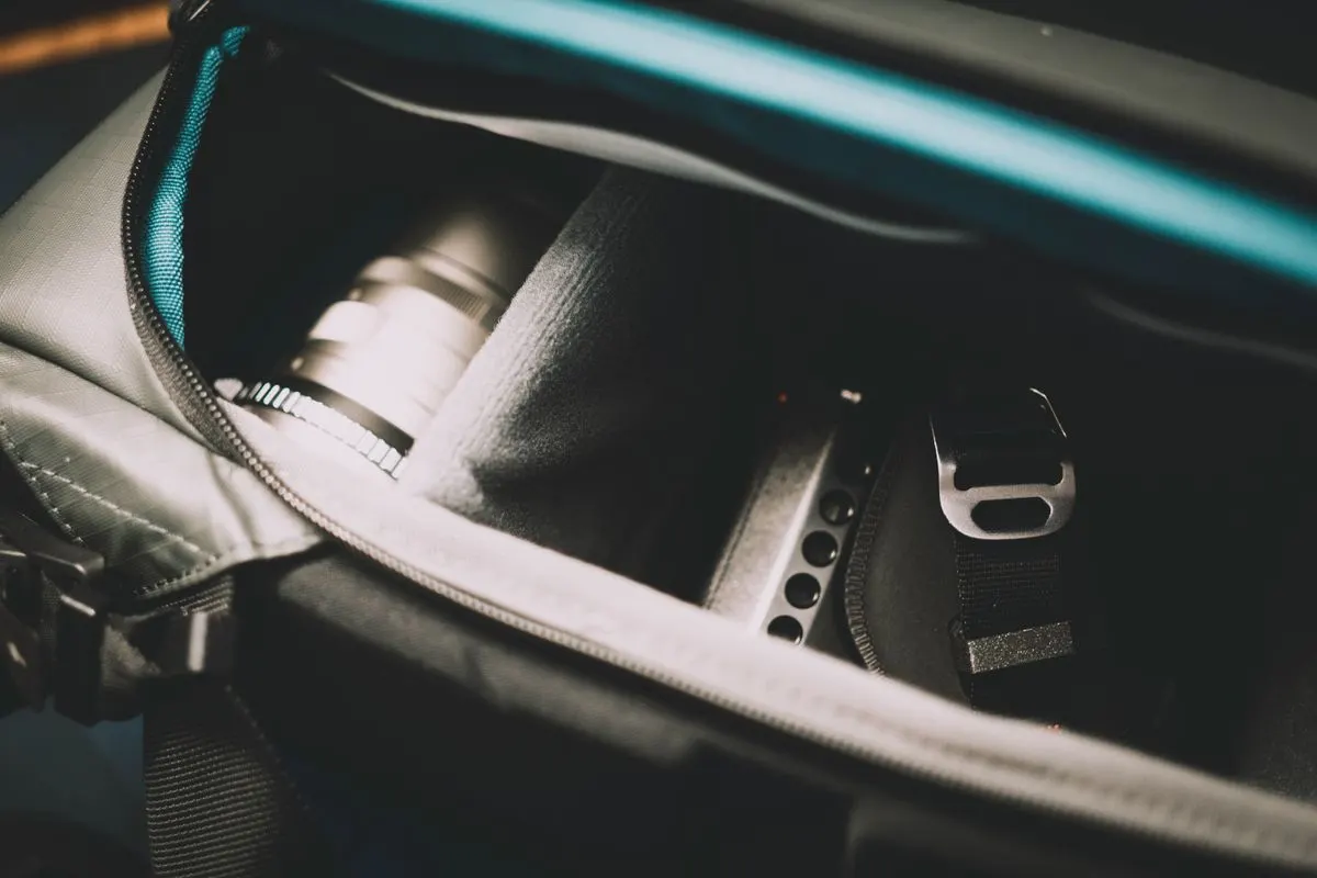 Close-up view of camera equipment stored securely in a padded bag, showcasing travel readiness.