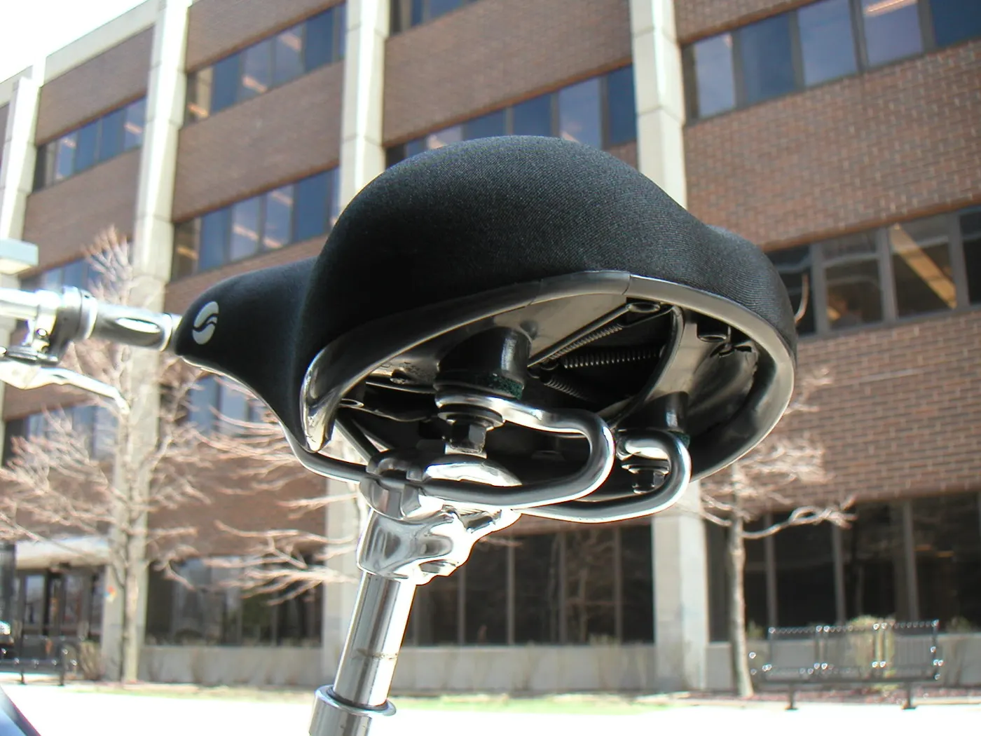 Bicycle saddle with springs and a clamp